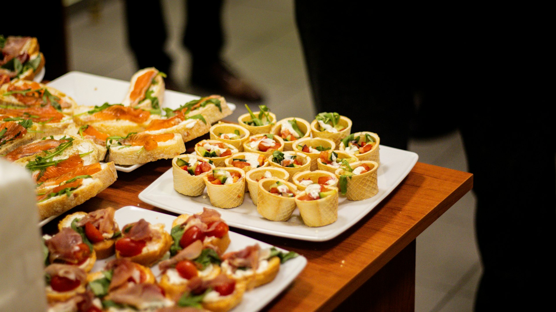 a wooden table topped with plates of food